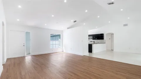 a view of kitchen with microwave and refrigerator