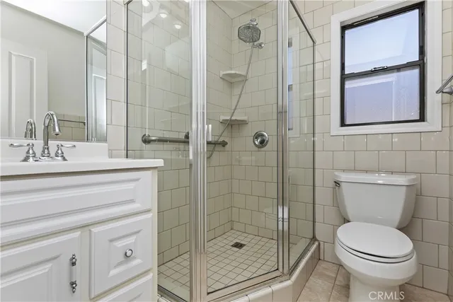 a view of a bedroom with wooden floor and a ceiling fan