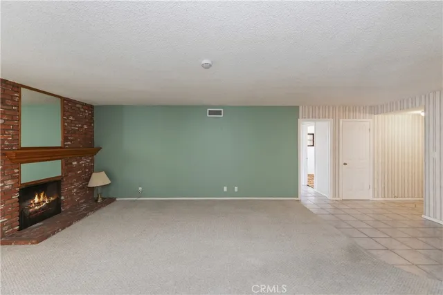 a view of an empty room with fire place