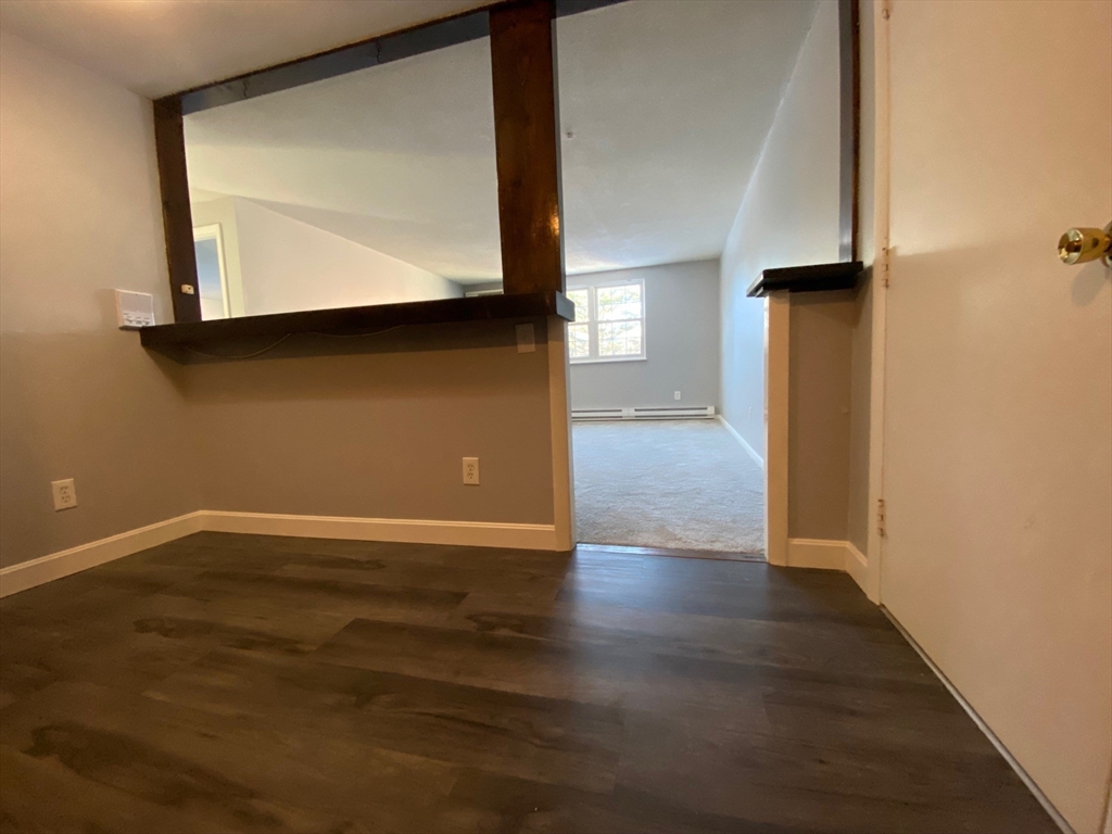 30 Leonard Road, Unit 30 Boxborough, MA 01719 - Photo 14 of 30 a view of an empty room with wooden floor and a window