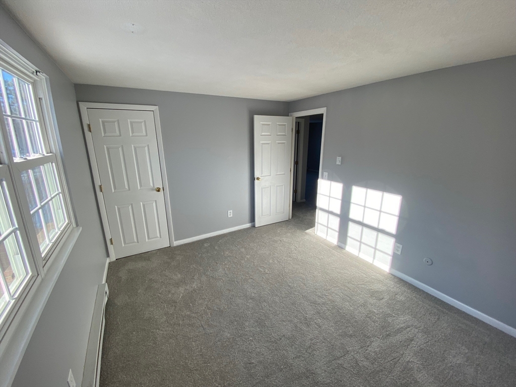 30 Leonard Road, Unit 30 Boxborough, MA 01719 - Photo 16 of 30 an empty room with windows
