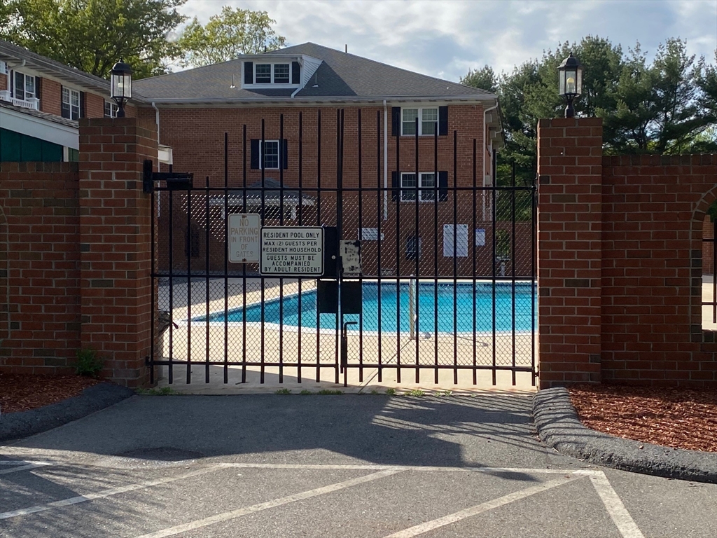 30 Leonard Road, Unit 30 Boxborough, MA 01719 - Photo 22 of 30 a view of a brick house with a iron gate