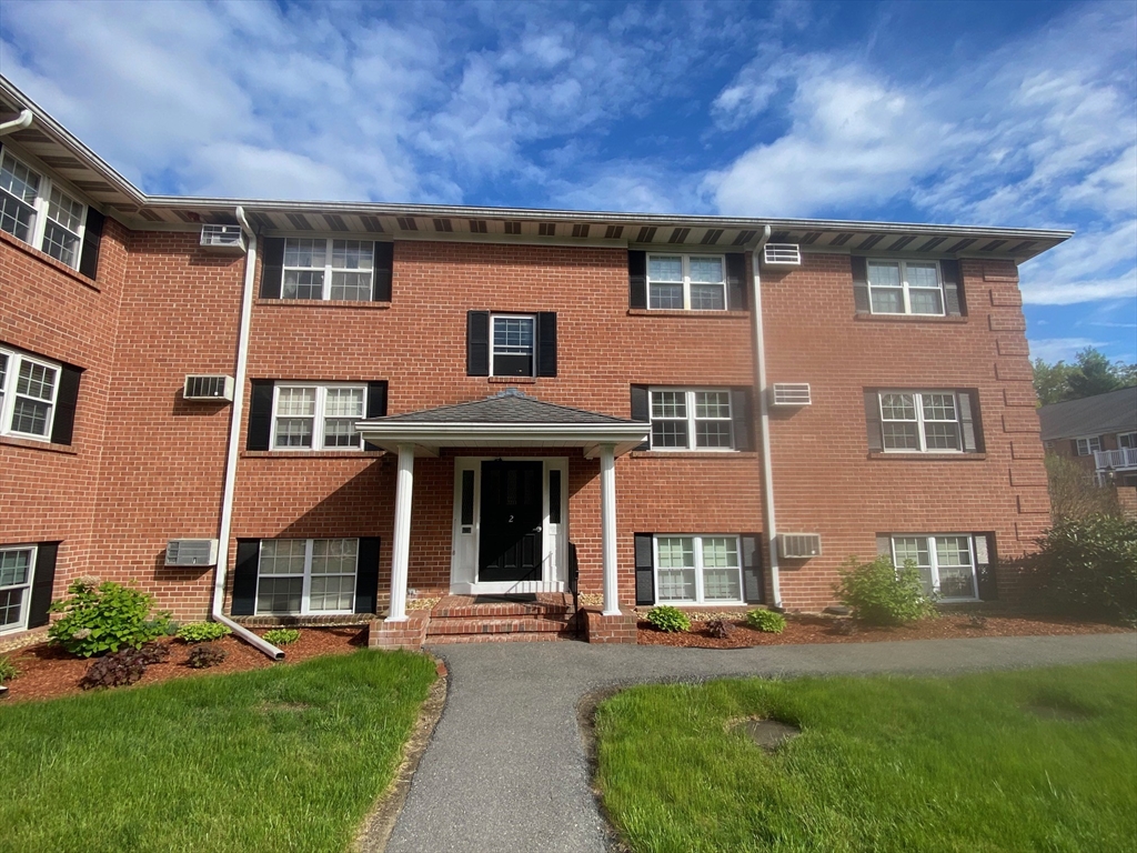 30 Leonard Road, Unit 30 Boxborough, MA 01719 - Photo 27 of 30 front view of a brick house with a yard and large trees