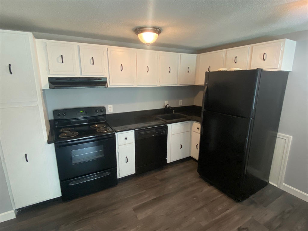 30 Leonard Road, Unit 30 Boxborough, MA 01719 - Photo 3 of 30 a kitchen with a refrigerator and a stove