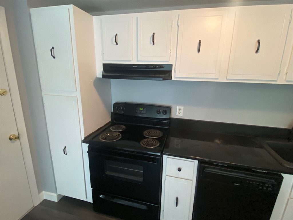 30 Leonard Road, Unit 30 Boxborough, MA 01719 - Photo 4 of 30 a kitchen with a stove and white cabinets