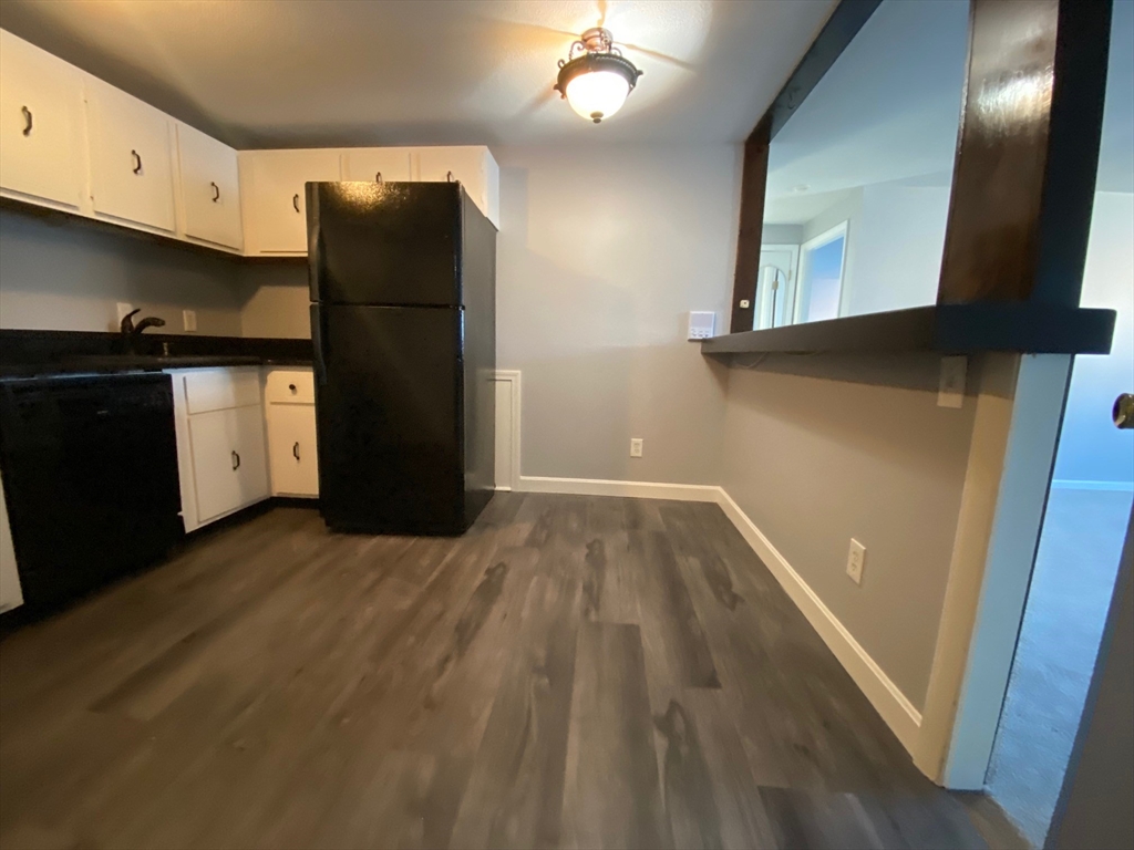 30 Leonard Road, Unit 30 Boxborough, MA 01719 - Photo 6 of 30 a view of an empty room with wooden floor and a window