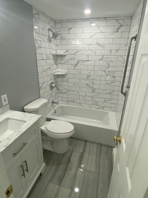 30 Leonard Road, Unit 30 Boxborough, MA 01719 - Photo 8 of 30 a bathroom with a granite countertop bathtub shower sink vanity and toilet