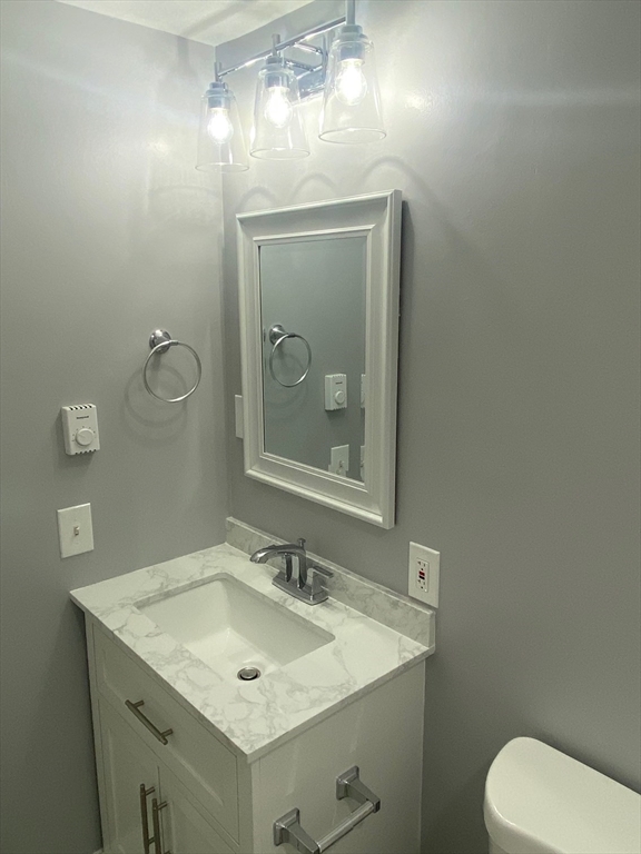 30 Leonard Road, Unit 30 Boxborough, MA 01719 - Photo 10 of 30 a bathroom with a toilet sink and mirror