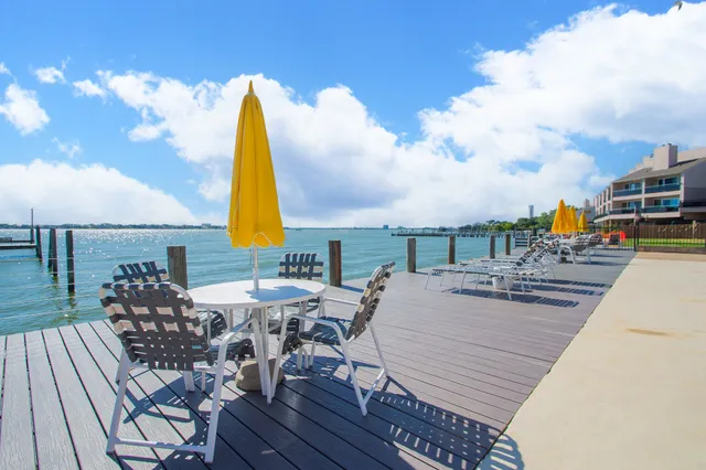 a view of a rooftop deck with couch and chairs