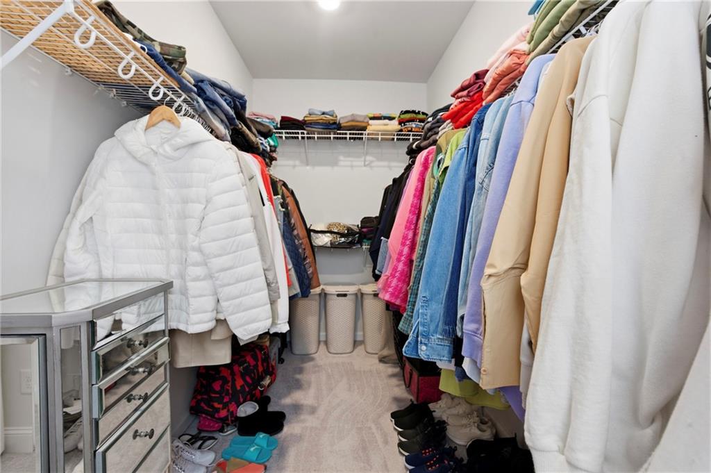 3880 Pr Fld Crossing Suwanee, GA 30024 - Photo 20 of 51 a view of walk in closet with clothes and shoes
