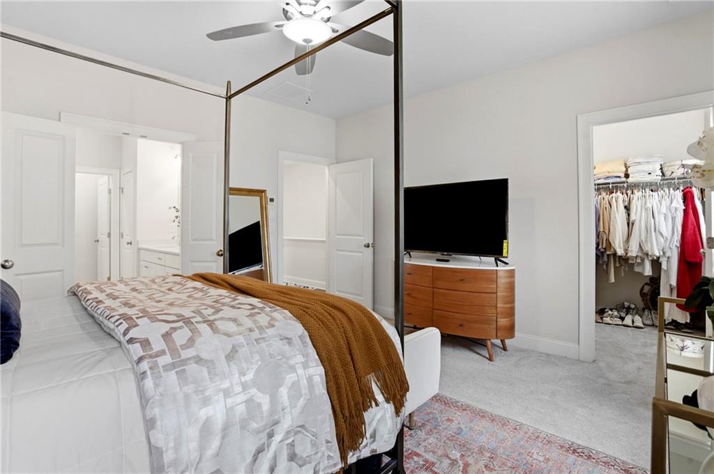 3880 Pr Fld Crossing Suwanee, GA 30024 - Photo 21 of 51 a bedroom with a bed and a flat tv screen