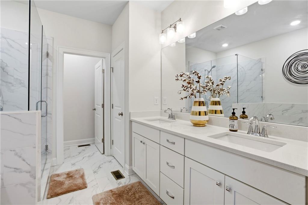 3880 Pr Fld Crossing Suwanee, GA 30024 - Photo 23 of 51 a bathroom with a sink double vanity and a mirror
