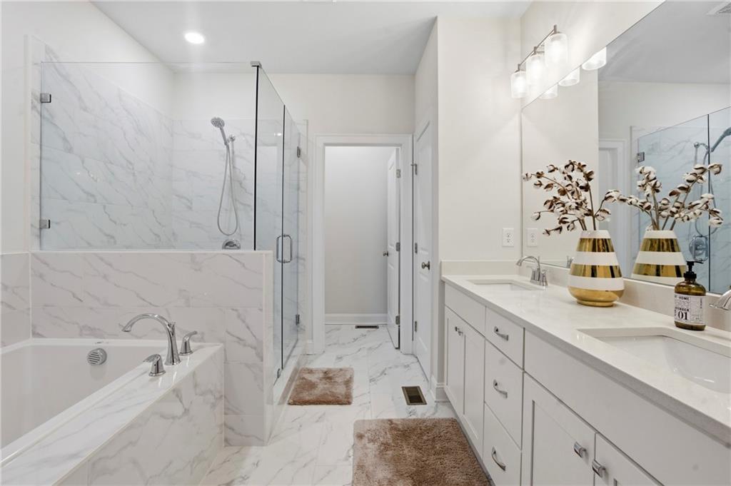 3880 Pr Fld Crossing Suwanee, GA 30024 - Photo 24 of 51 a spacious bathroom with a tub sink a shower and a mirror