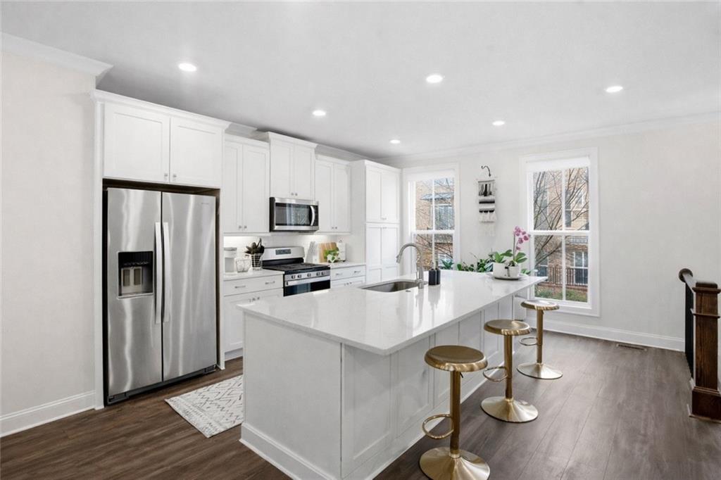 3880 Pr Fld Crossing Suwanee, GA 30024 - Photo 4 of 51 a large kitchen with a center island appliances and wooden floor