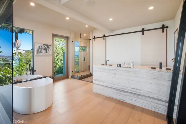 a spacious bathroom with a tub shower and window