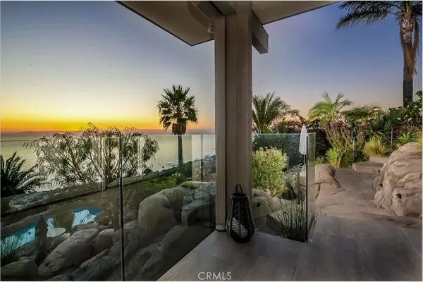 a view of a balcony with plants and a palm tree