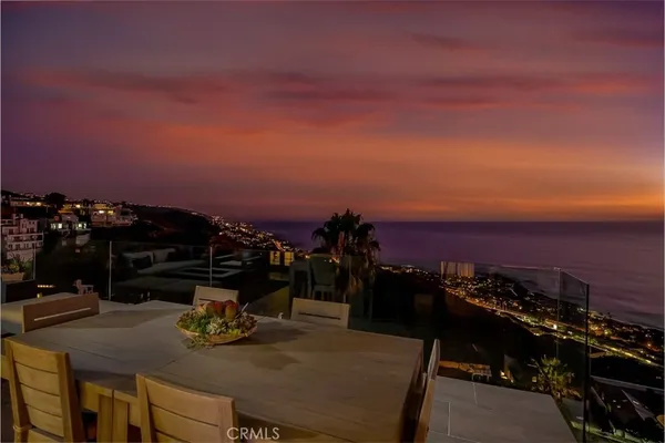 a view of a terrace with furniture and city view