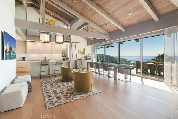 a living room with lots of furniture and a floor to ceiling window