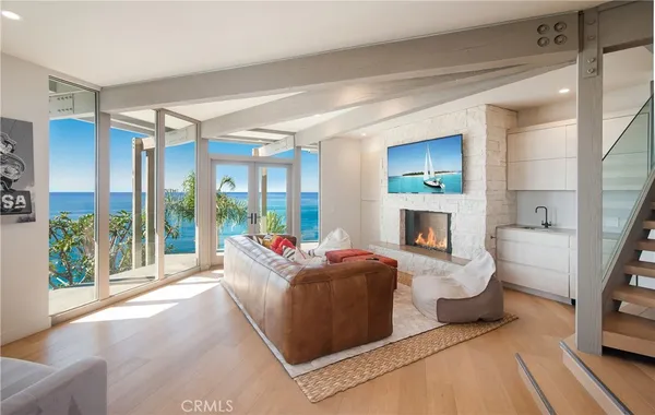 a living room with fireplace furniture and a large window