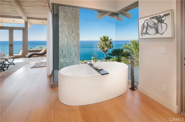 a white bath tub sitting in a bathroom next to a sink