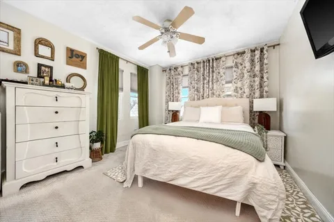 a bedroom with a large bed and a chandelier