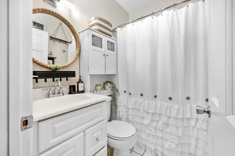 a bathroom with a sink a toilet and a mirror