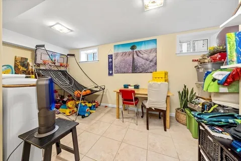 a view of a play room with furniture and toys