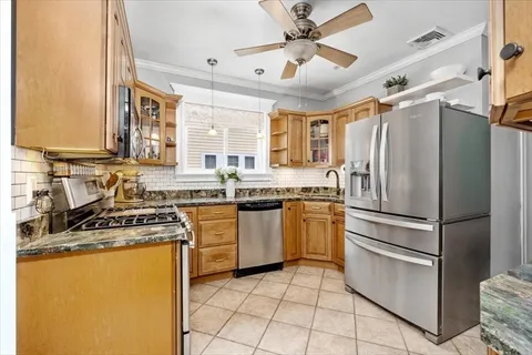 a kitchen with a refrigerator a sink and a stove