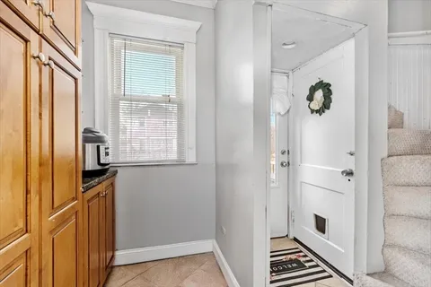 a view of kitchen with furniture and electronic appliances