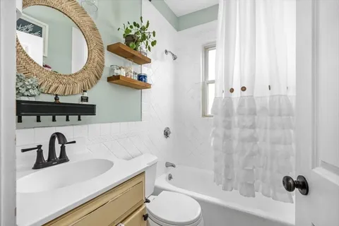 a bathroom with a sink a toilet and a mirror