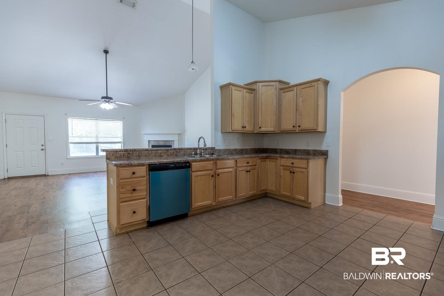 101 Normandy Street Fairhope, AL 36532 - Photo 5 of 18 Kitchen with a ceiling fan, high vaulted ceiling, dark countertops, arched walkways, and dishwashing machine