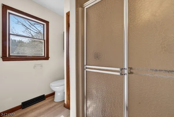 a bathroom with a toilet and a shower