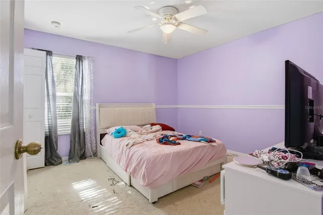 a bedroom with furniture and a chandelier