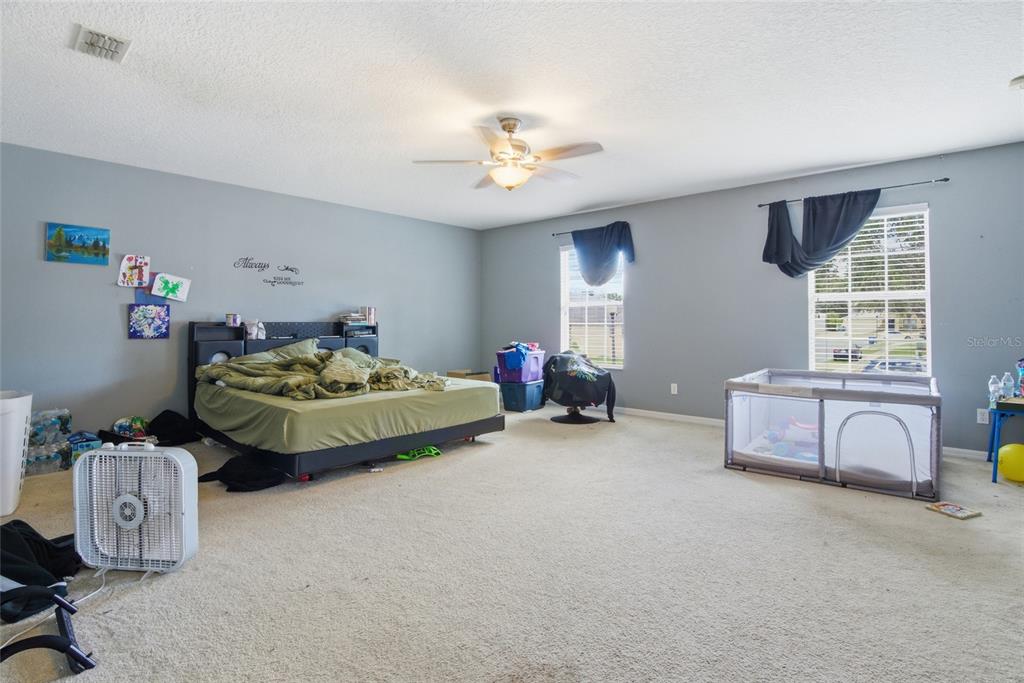 2463 Martins Run Tavares, FL 32778 - Photo 19 of 24 a bedroom with furniture and a chandelier