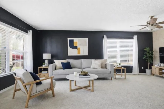 a living room with furniture and a large window