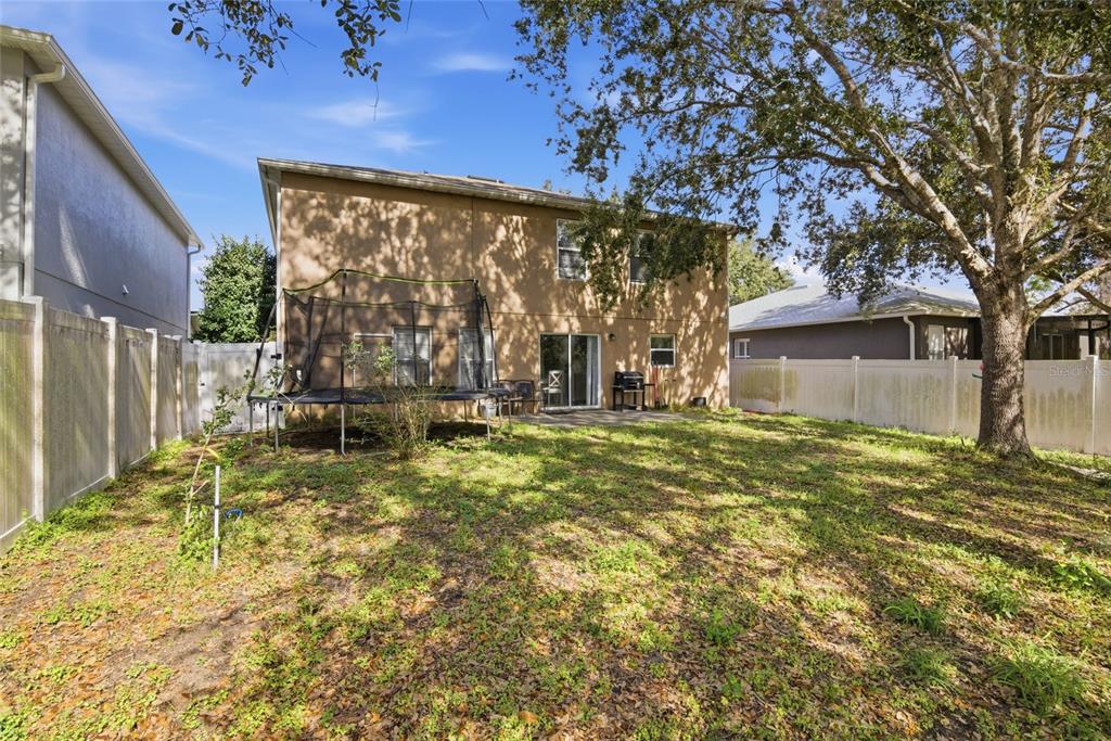 2463 Martins Run Tavares, FL 32778 - Photo 21 of 24 a backyard of a house with table and chairs