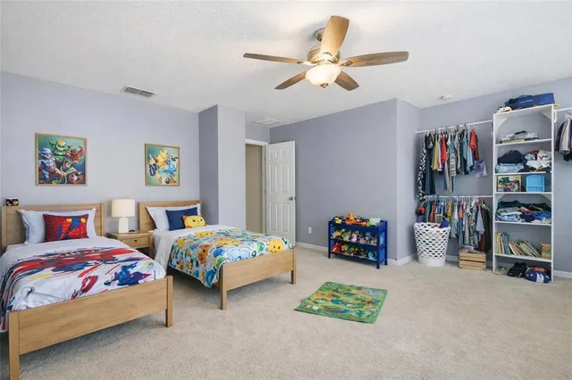 a bedroom with two beds and a chandelier