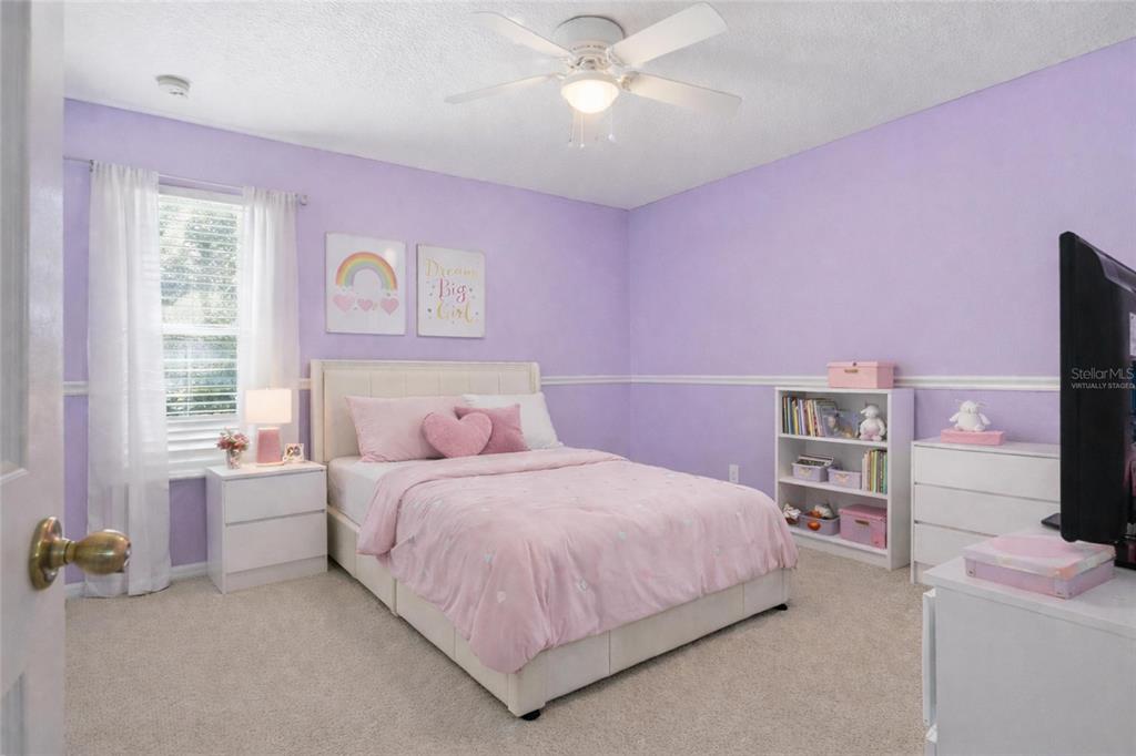 2463 Martins Run Tavares, FL 32778 - Photo 8 of 24 a bedroom with a bed and a flat screen tv