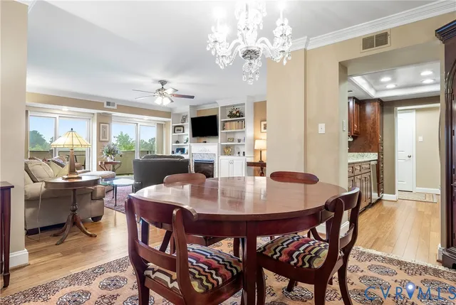 a view of a dining room with furniture and chandelier