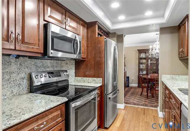 a bathroom with a granite countertop sink a vanity and a large mirror