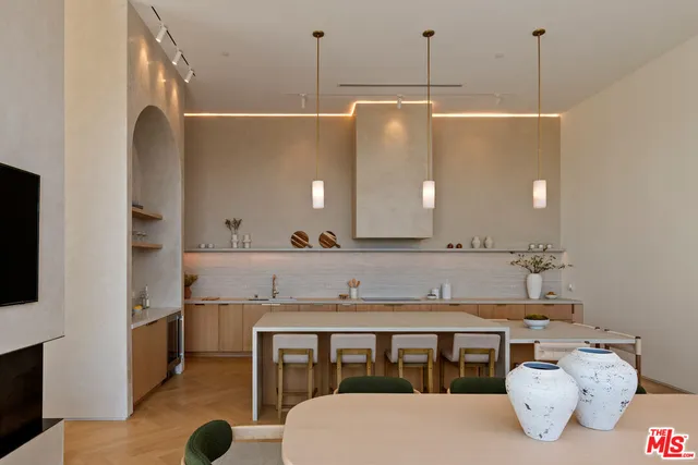 a kitchen with a table chairs sink and cabinets