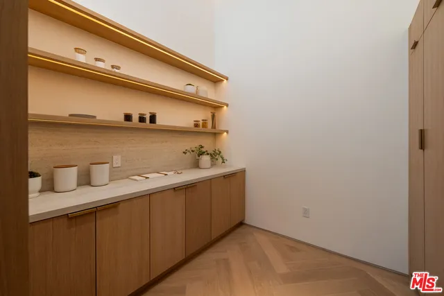 a kitchen with kitchen island granite countertop wooden cabinets a sink and a stove