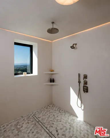 a bedroom with a bed and a large window