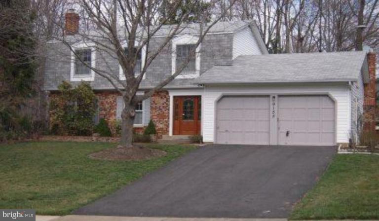 9155 Rockefeller Lane Springfield, VA 22153 - Photo 1 of 15 a front view of a house with a yard and garage