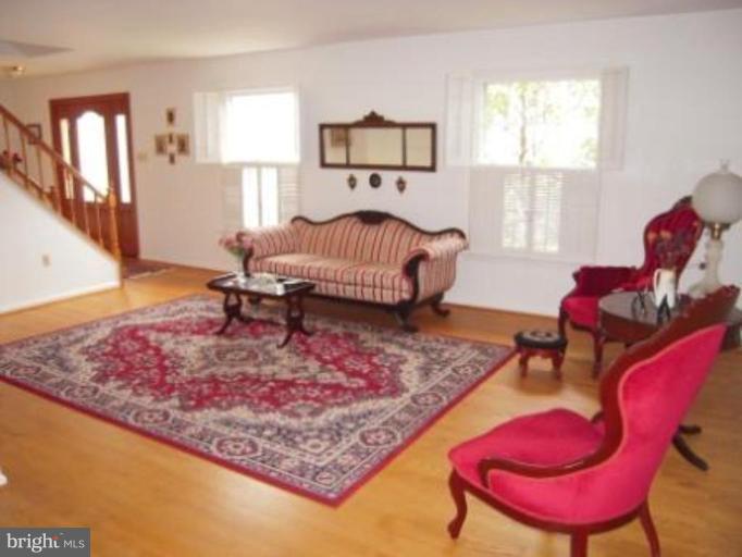 9155 Rockefeller Lane Springfield, VA 22153 - Photo 2 of 15 a bedroom with a bed chair and window