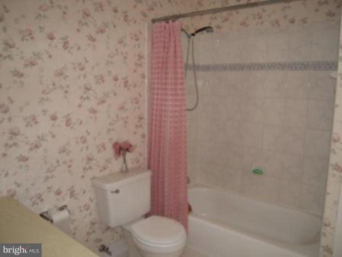 9155 Rockefeller Lane Springfield, VA 22153 - Photo 11 of 15 a bathroom with a toilet and shower