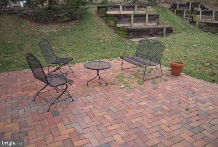 9155 Rockefeller Lane Springfield, VA 22153 - Photo 14 of 15 a backyard of a house with table and chairs