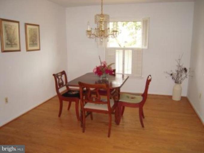 9155 Rockefeller Lane Springfield, VA 22153 - Photo 3 of 15 a view of a dining room with furniture and a chandelier