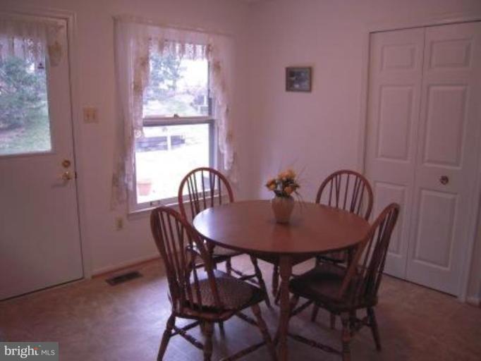 9155 Rockefeller Lane Springfield, VA 22153 - Photo 5 of 15 a view of a dining room with furniture and window