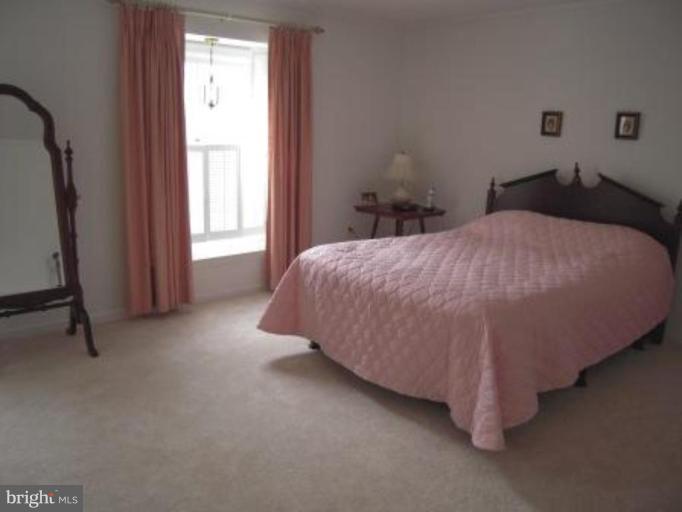 9155 Rockefeller Lane Springfield, VA 22153 - Photo 7 of 15 a bedroom with a bed and a window